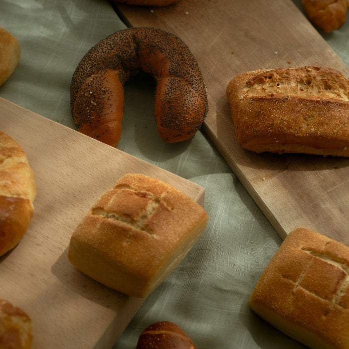 a table topped with lots of different types of bread