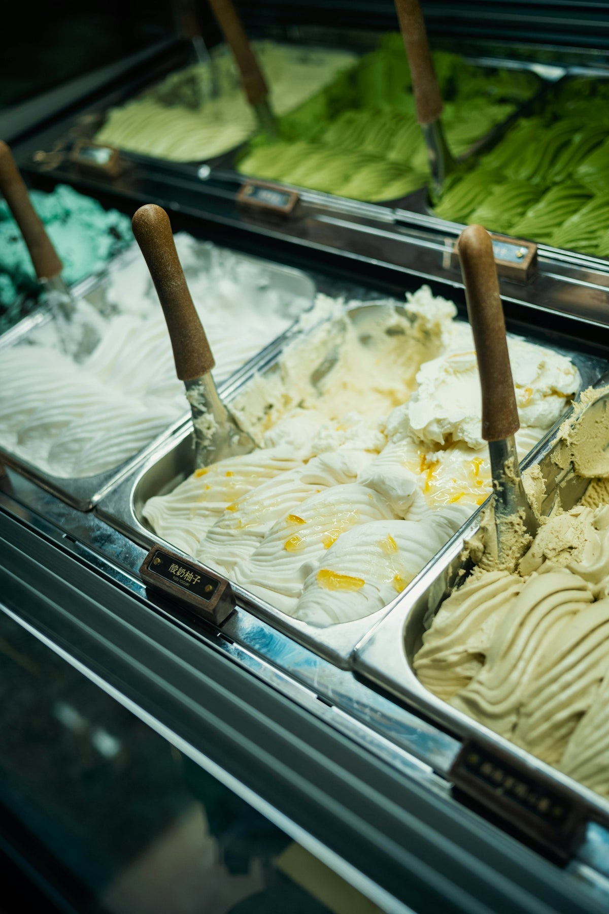 Gelato flavors are displayed in a glass case