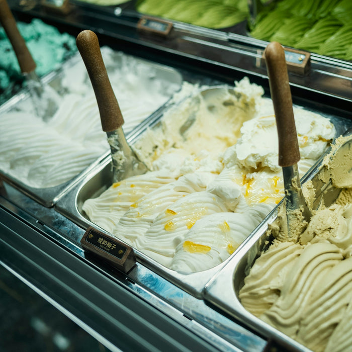 Gelato flavors are displayed in a glass case
